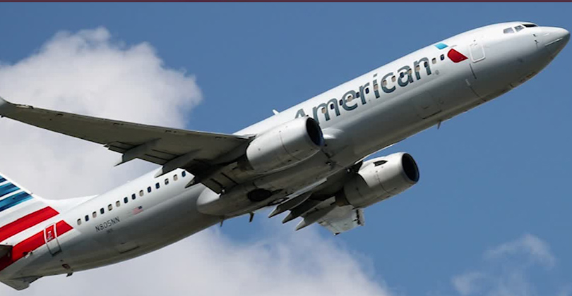 Picture of an American Airlines airplane bringing patients to Frontline Dental in San Jose, Costa Rica.  The airplane is ascending and shows American Airlines new colors.